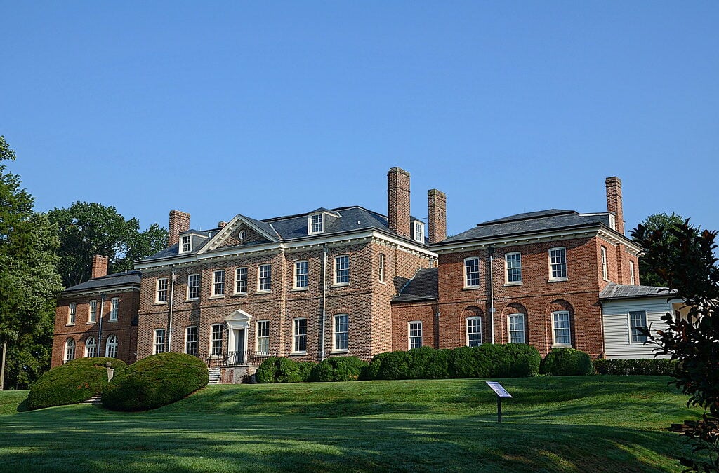Brick Georgian-style mansion with a wide front lawn