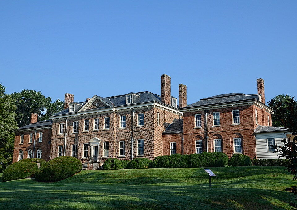 Brick Georgian-style mansion with a wide front lawn