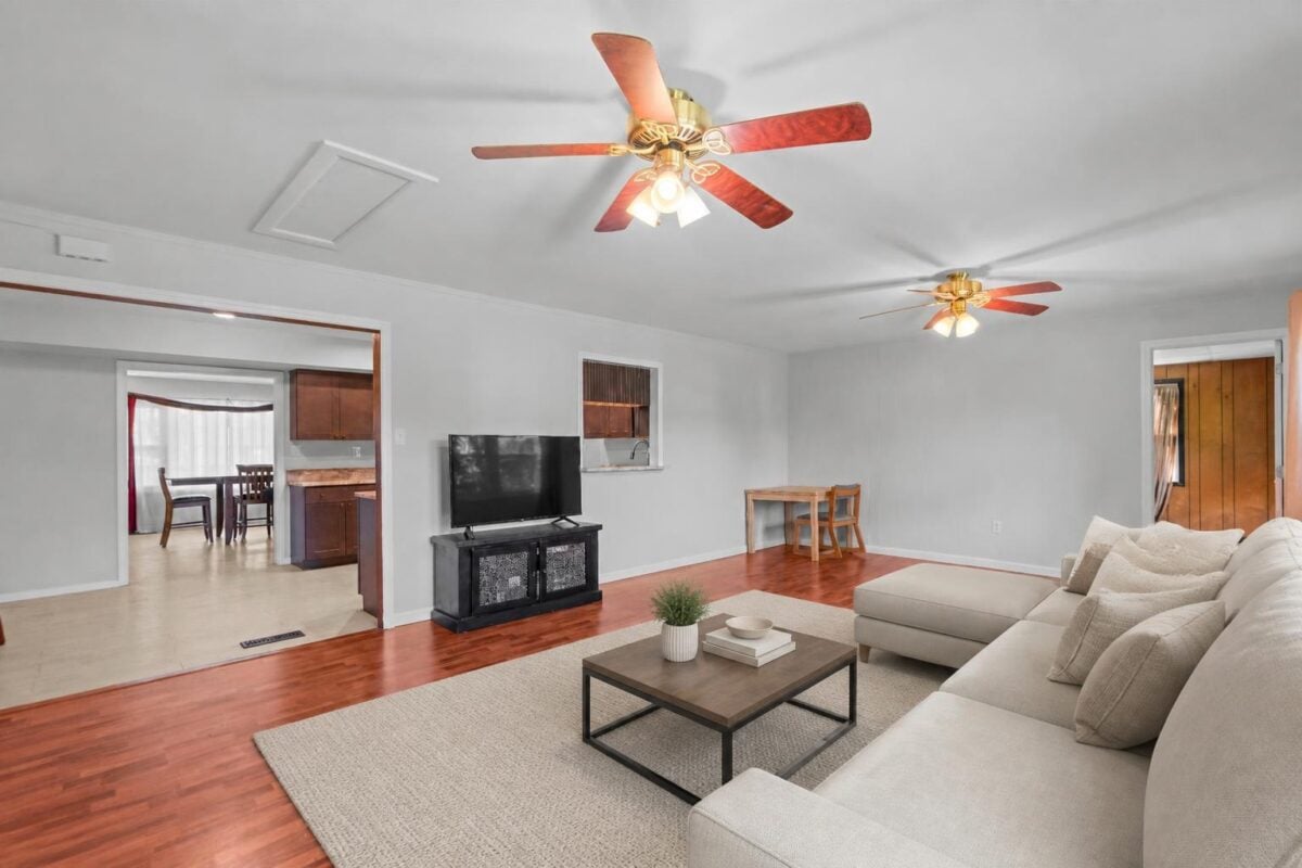 Family room opening to the kitchen, virtually staged